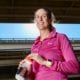 Woman in under armor pink half zip and clif water bottle