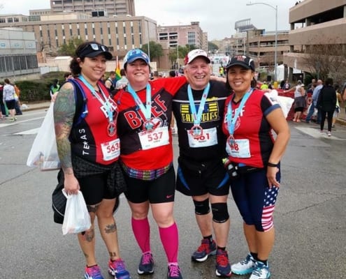 Best friends pose with medals after marathon