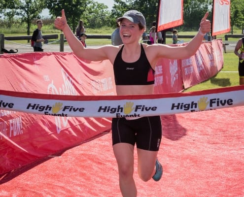 Woman happily crosses finish line