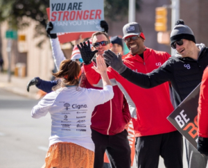 CG trainers cheer on runners at the 2019 3M Half Marathon. Expand your summer training with Camp Gladiator trainers!