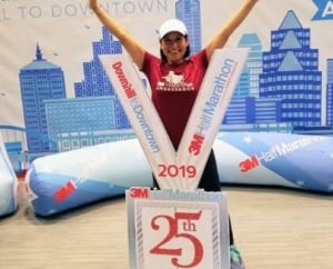 Sara Ferniza, 2020 3M Half Ambassador, poses with giant 2019 3M Half Marathon medal.