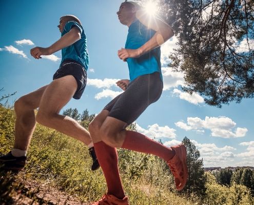 Two trail runners run together to stay safe.