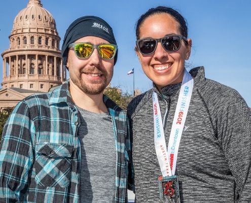 Couple poses in front of Texas State Capitol after 2019 3M Half Marathon. Get to know Austin when you visit the places in our blog, like the Texas State Capitol.