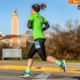 Participant runs through the University of Texas during the 2019 3M Half Marathon. 2020 participants can download the free half marathon training plan that'll get them to the finish line!
