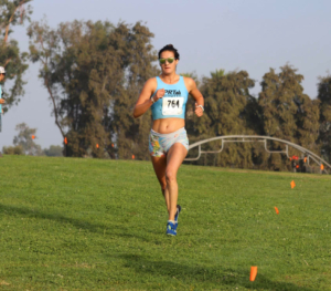Image Sofie Schunk running a race on an open field. Schunk will run with the 2020 elite field at the 2020 3M Half Marathon presented by Under Armour.