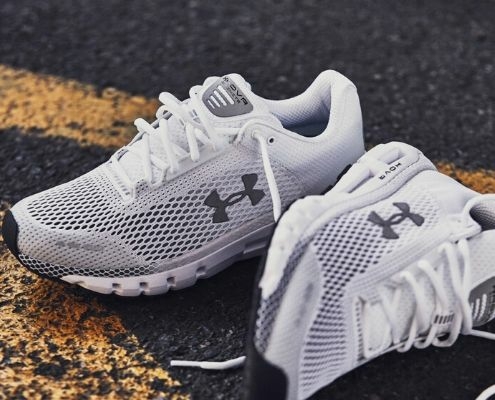 A pair of white Under Armour shoes: the HOVR Infinites.