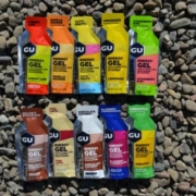 Image of 10 different flavored GU Energy Gels laying on the ground. GU Energy Labs is the Official Energy Gel and Chew of the 2020 3M Half Marathon presented by Under Armour.
