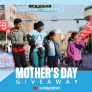 Image of a mother crossing the 2019 3M Half Marathon finish line with her three kids walking beside her. Enter your mom to the 3M Half Marathon Mother's Day Giveaway and she could win a free SPIbelt!