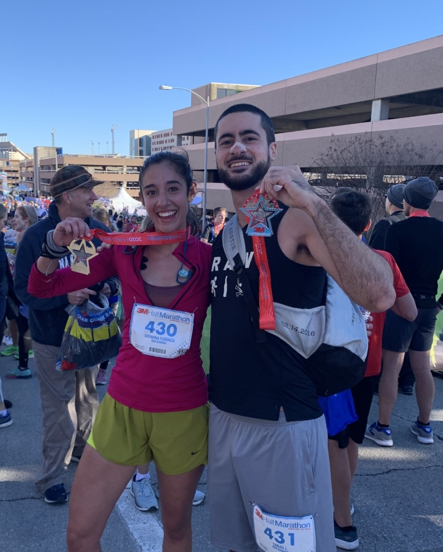 Image of a male and female runner showcasing their 2020 3M Half Marathon finisher medals at the finish line festivals. Run your first half marathon at 3M Half Marathon and cross your first 13.1-mile finish line and join runners like these two.