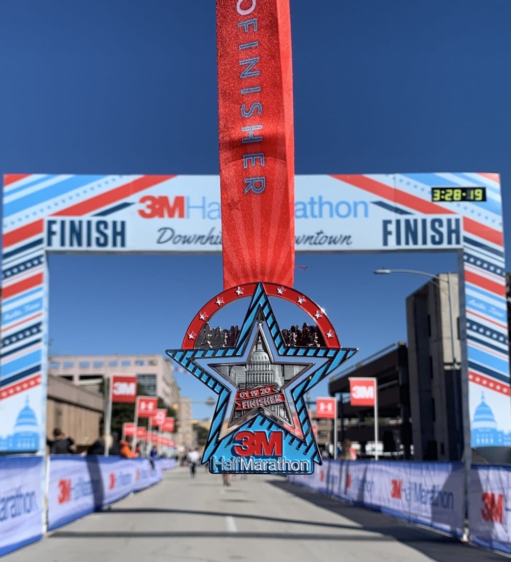 Image of the 2020 3M Half Marathon with the finish line in the background. Run your first half marathon at 3M Half Marathon and this commemorative spinner finisher medal is just one of the perks you'll receive!