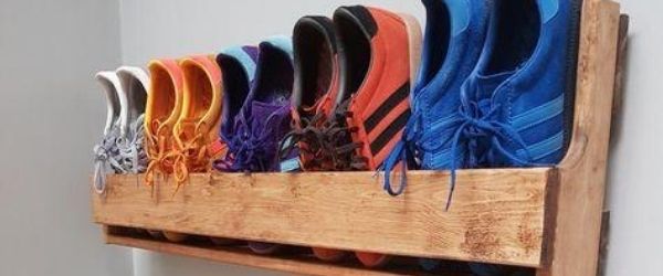 5 pair of running shoes are tucked into a hand-built wooden rack that hangs from the wall. It's an example of different ways to organize your running shoes. Click on the image's link to visit 3M Half Marathon's Pinterest page for more ideas.