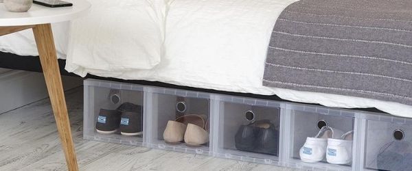 Various plastic containers store pairs of shoes under a bed as an example of different ways to organize your running shoes. Click on the image's link to visit 3M Half Marathon's Pinterest page for more ideas.