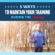 Female runner runs on a cold day. Text on design reads 5 Ways to Maintain Your Training During the Holidays. Read more at https://downhilltodowntown.com/training-during-the-holidays/