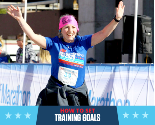 Female runner crosses the 3M Half Marathon with her arms raised triumphantly in the air. Text on design reads How to Set Training Goals. Learn more at http://im8.22e.myftpupload.com/set-training-goals/